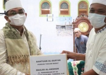 Bupati Tanjabbar saat serahkan bantuan pembangunan Masjid Al Anshor secara simbolis (foto: tif)
