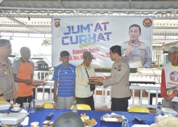 Kabid Humas Polda Jambi, Kombes Pol Mulia Prianto, menyerahkan bantuan beras kepada salah satu masyarakat yang hadir dalam kegiatan Jum'at Curhat, (10/2/2023). (Foto Humas Polda Jambi)